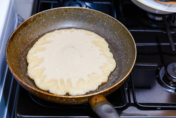 preparing homemade pancakes cooking, in a pan.Cooking pancakes in a pan.Homemade pancakes.Closeup.