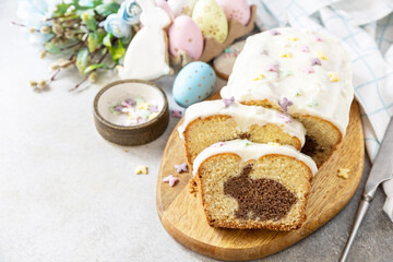 Obraz na płótnie Canvas Happy Easter holiday food baking, cupcake with Easter Bunny and colorful eggs on stone background. Copy space.