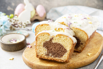 Happy Easter holiday food baking, cupcake with Easter Bunny and colorful eggs on stone background.