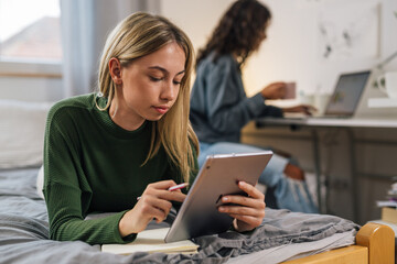 Two young woman study together in silence