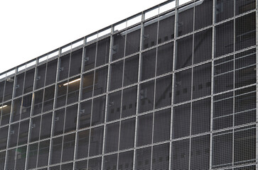 steel cladding of a building with a expanded metal lattice structure. galvanized gray nets protect...