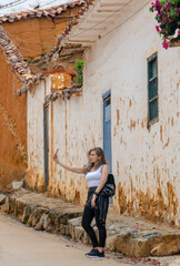 Fototapeta na wymiar beautiful blonde woman traveling through towns and making stops on the road enjoying the trip walking through old streets