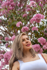 Fototapeta premium beautiful blonde woman traveling through towns and making stops on the road enjoying the trip walking through old streets
