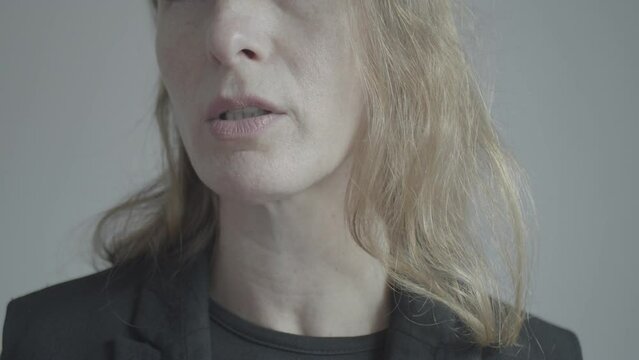 Speaking. Portrait of part of the face of a pleasant Caucasian woman who is talking and smiling. Positive emotions. Captivating monologue.