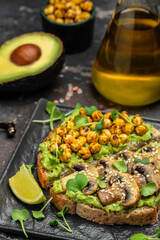 Mashed avocado, mushrooms and chickpea toasts. Delicious breakfast or snack, Clean eating, dieting, vegan food concept. top view