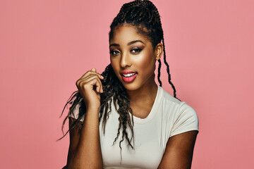 woman with red lips and braids looking at camera