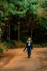 Beautiful blonde woman traveling by motorcycle through old towns walking and walking through its streets and mountains full of gardens enjoying the beautiful views and landscapes on vacation