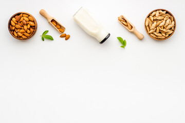 Sweet almond milk in bottle with almond seeds