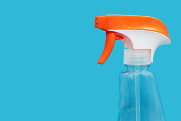 Plastic transparent bottle with detergent on a blue background with a spray bottle. Detergent for...