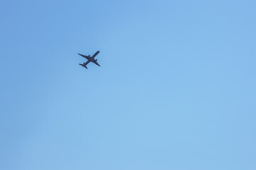 Low Angle View Of Silhouette Airplane Against Clear Blue Sky
