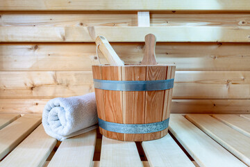 Fototapeta na wymiar Detail from buckets and white towels in a sauna, wellness accessories