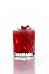 red alcoholic cocktail with berries and frappe in an old fashioned glass