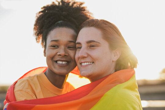 Multiracial female couple having tender moment at sunset - LGBT concept