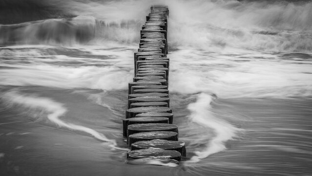 Stormy Wave Crashing On The Beach Against The Stormy Sky