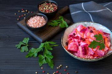 Sauerkraut in a bowl on a wooden table. Healthy fermented food rich in vitamins, antioxidants, fiber.