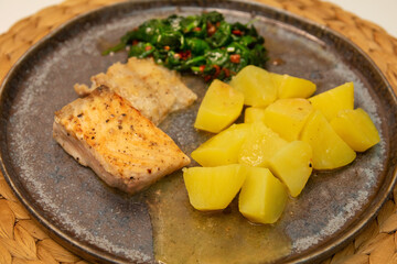 Healthy omega-3 rich salmon, nutrient-packed spinach, classic salty potatoes on a table - 571357099