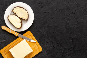Spreading butter with knife on toast bread. Top view