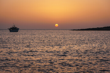 Fototapeta na wymiar Sunset in Coral Bay resort in Pegeia city, Cyprus island country
