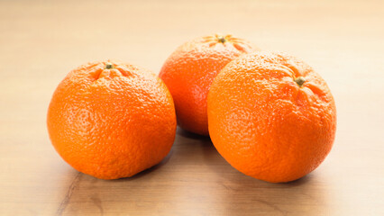 Mandarine on wooden table. Ripe citrus fruit on the wooden table.Tangerines juicy fruits on wooden background