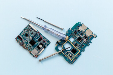 Electronics checkup - circuit board with microchips and tools, top view