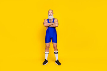 Full length photo of joyful sporty pensioner grandpa professional coach wear suit muscular arm crossed isolated on yellow color background