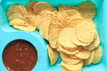 a bowl of chips and salsa on table ,
