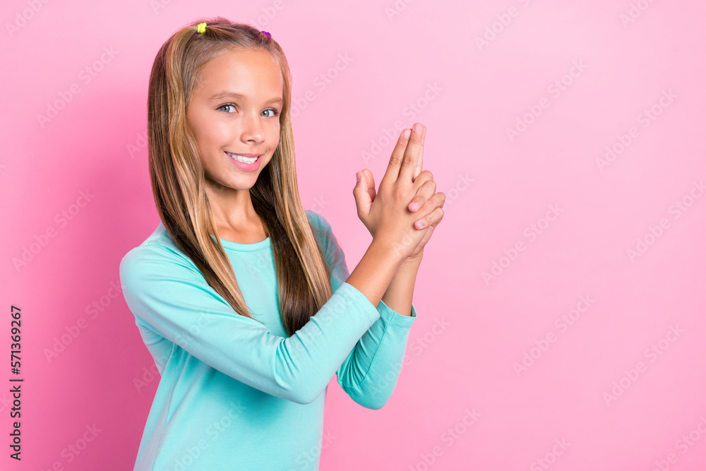 Wall mural Photo of young little preteen schoolkid girl hold abstract fingers pistol weapon toothy smile confident playful isolated on bright pink color background