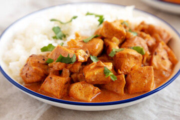 Homemade Easy Indian Butter Chicken with Rice on a Plate, side view. Close-up.