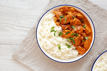 Homemade Easy Indian Butter Chicken with Rice on a Plate, top view. Flat lay, overhead, from above. Copy space.