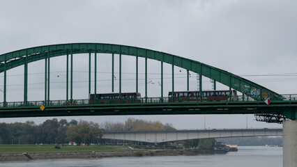 Old bridge across Sava river in Belgrade, green arch bridge