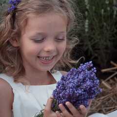 Girl in lavender field. Girl in white dress with a bouquet of lavender.