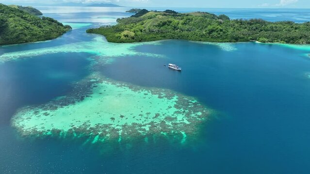 Shallow coral reefs grow inside a remote, scenic lagoon in the Solomon Islands. This beautiful, tropical country is home to spectacular marine biodiversity and many historic World War II sites.