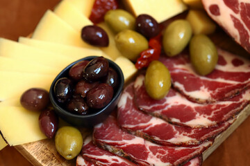 Italian board. Cheese, olives, prosciutto, pesto.