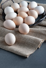 Chicken eggs in metal tray on burlap background