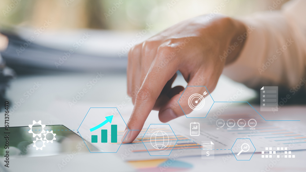 Aufkleber accountant calculating numbers ,and growth graphs in company financial documents, analysis of compan