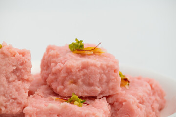 Indian Mithai Rose Kalakand Also Called Pink Gulabi Milk cake Is Milk Based Sweet Made Of Curdled Khoa Doodh Khoya Chhena Khova Paneer Gulab Jal. Enjoyed On Deepawali, Rakshabandhan, Janmashtami Puja