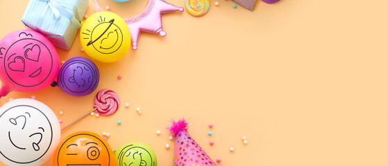 Obraz premium Birthday party decor and colorful balloons with drawn happy emoticons on beige background with space for text