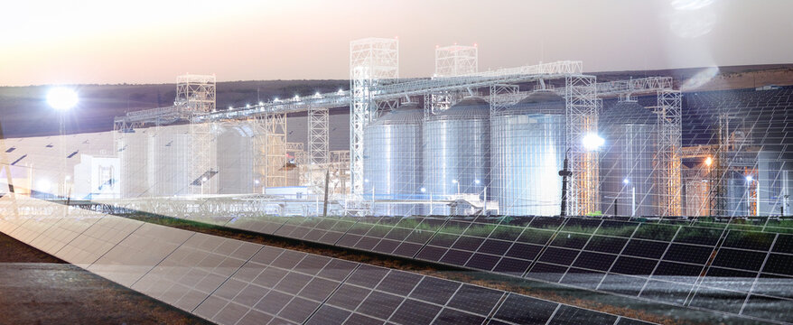 Multiple Exposure Of Solar Panels For Electric Power And Grain Elevators At Sunset