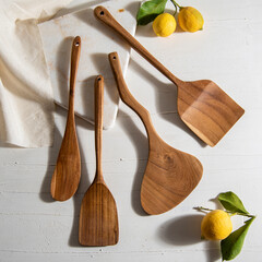 wooden spatulas with lemons on white table