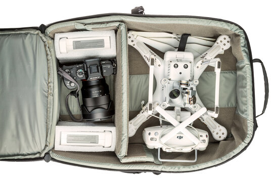 Fort Collins, CO, USA - March 09, 2016:  Photographer's backpack with DJI Phantom 3 quadcopter drone,  a set of propellers, radio controller, and spare batteries and Sony A7r mark 2 mirrorless camera.