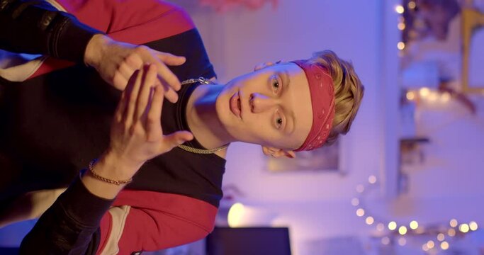 Gesticulating man in the making of an informational video. He moves his hands convincing his interlocutor, looks into the camera, moves his eyes. Red patch on forehead.