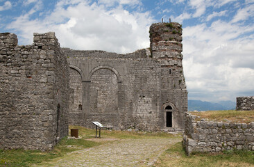 Fototapeta na wymiar The grass-covered ruins of the medieval Rozafa castle in Shkoder (Shkodra) with the clouds in the spring, Albania