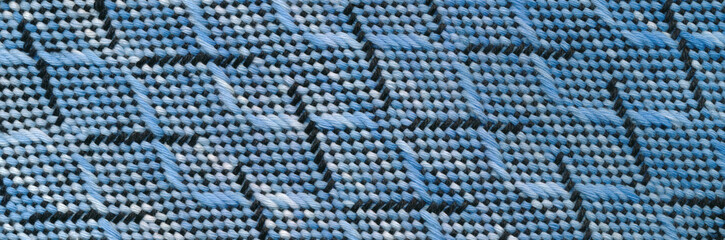 Close-up handwoven wavy pattern in black, blue and white.