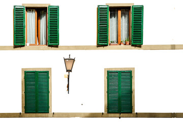 Four green shutters open and closed on a white facade - Powered by Adobe
