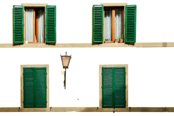 Four green shutters open and closed on a white facade isolated on white transparent background