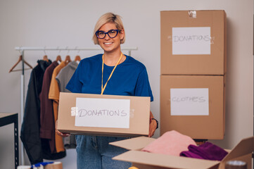 Portrait of a woman volunteer working in a charity donation center