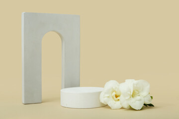 Podiums with beautiful flowers on beige background. Hello spring