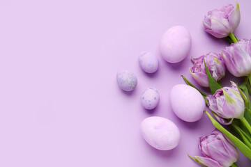Easter eggs and beautiful tulip flowers on lilac background