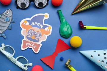 Set of party decor for April Fool's Day celebration on blue background