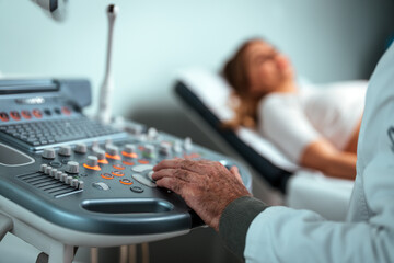 Sonographer using ultrasound machine at work. Modern clinical diagnostics and treatment. Close-up...